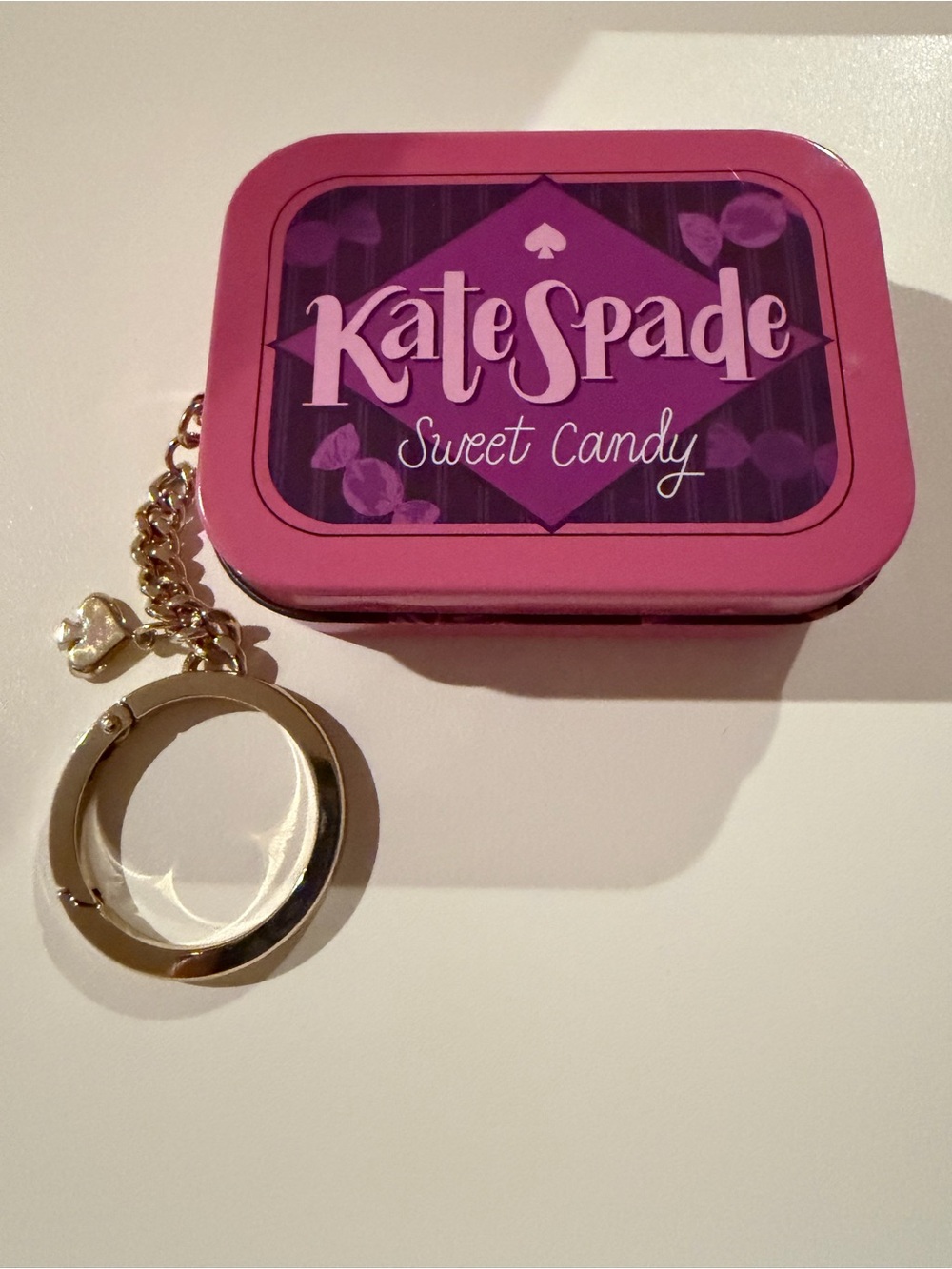 kate spade pink and purple Sweet Candy keychain tin with gold-tone hardware